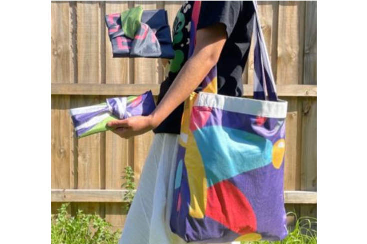 a photo of a person carrying a tote bag and some banners